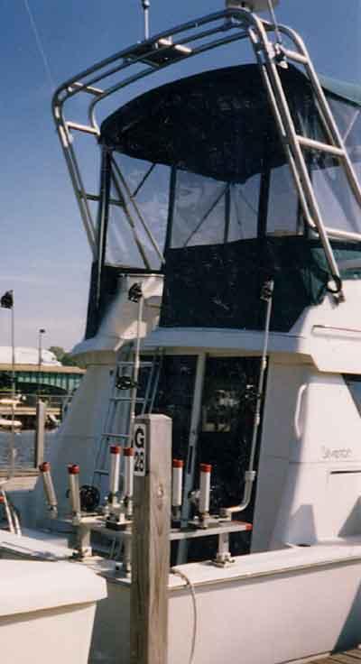 Atlantic Towers arch installed on the upper deck of a Silverton 31 Convertible boat docked at a marina.