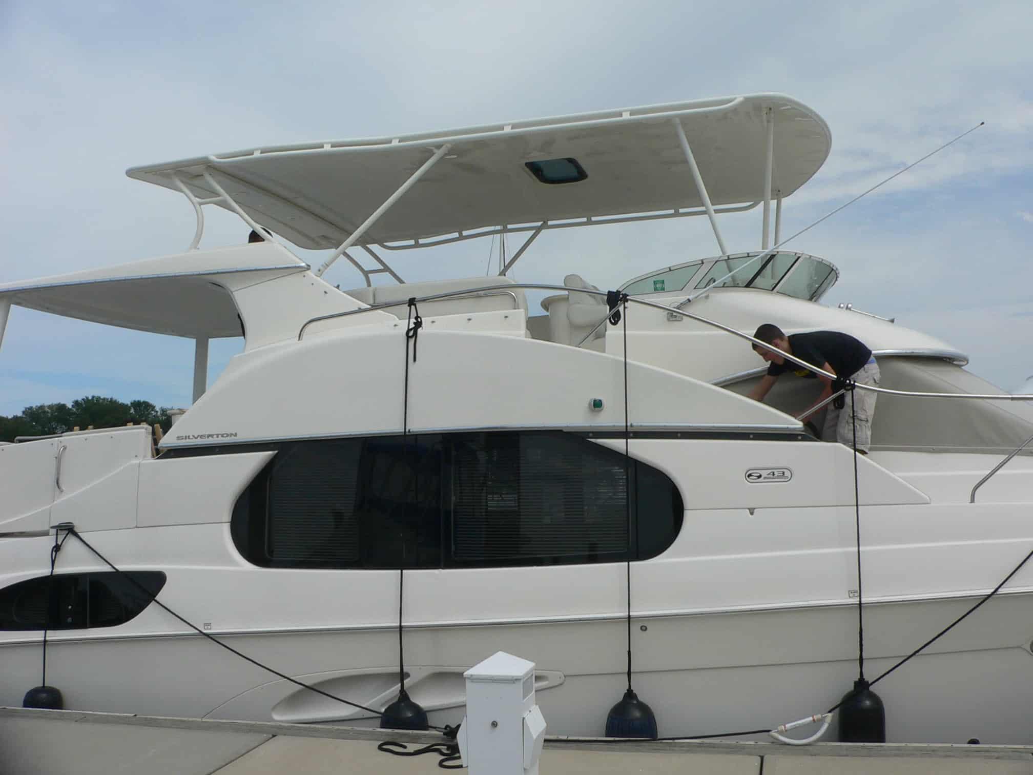 Atlantic Towers Top installed on a Silverton 372/392 Motor Yacht, with a person maintaining the boat.