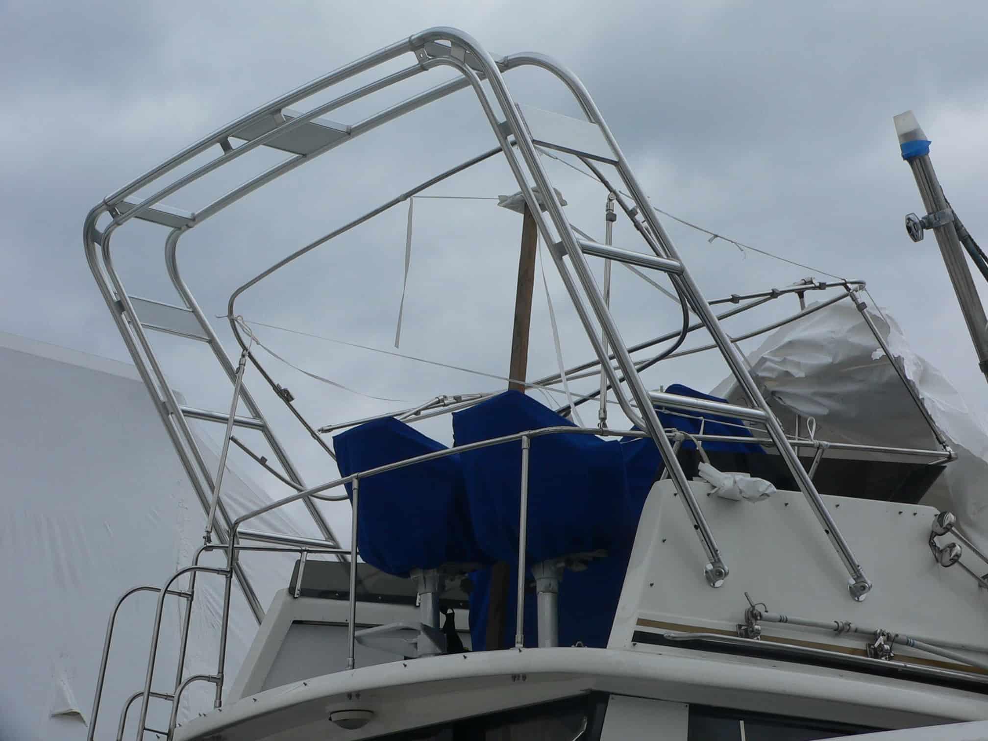 Atlantic Towers Arch installed on a Trojan F32 sedan boat shown from a side angle on calm water.
