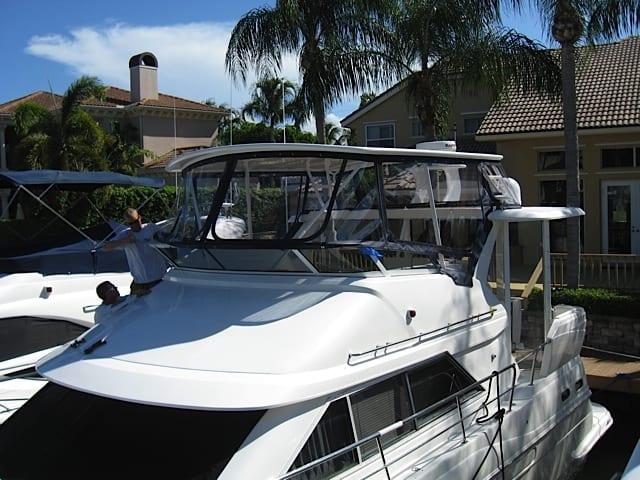 Cruisers 3650/3750/375 MY boat with Atlantic Towers Top installed, docked near residential waterfront homes.