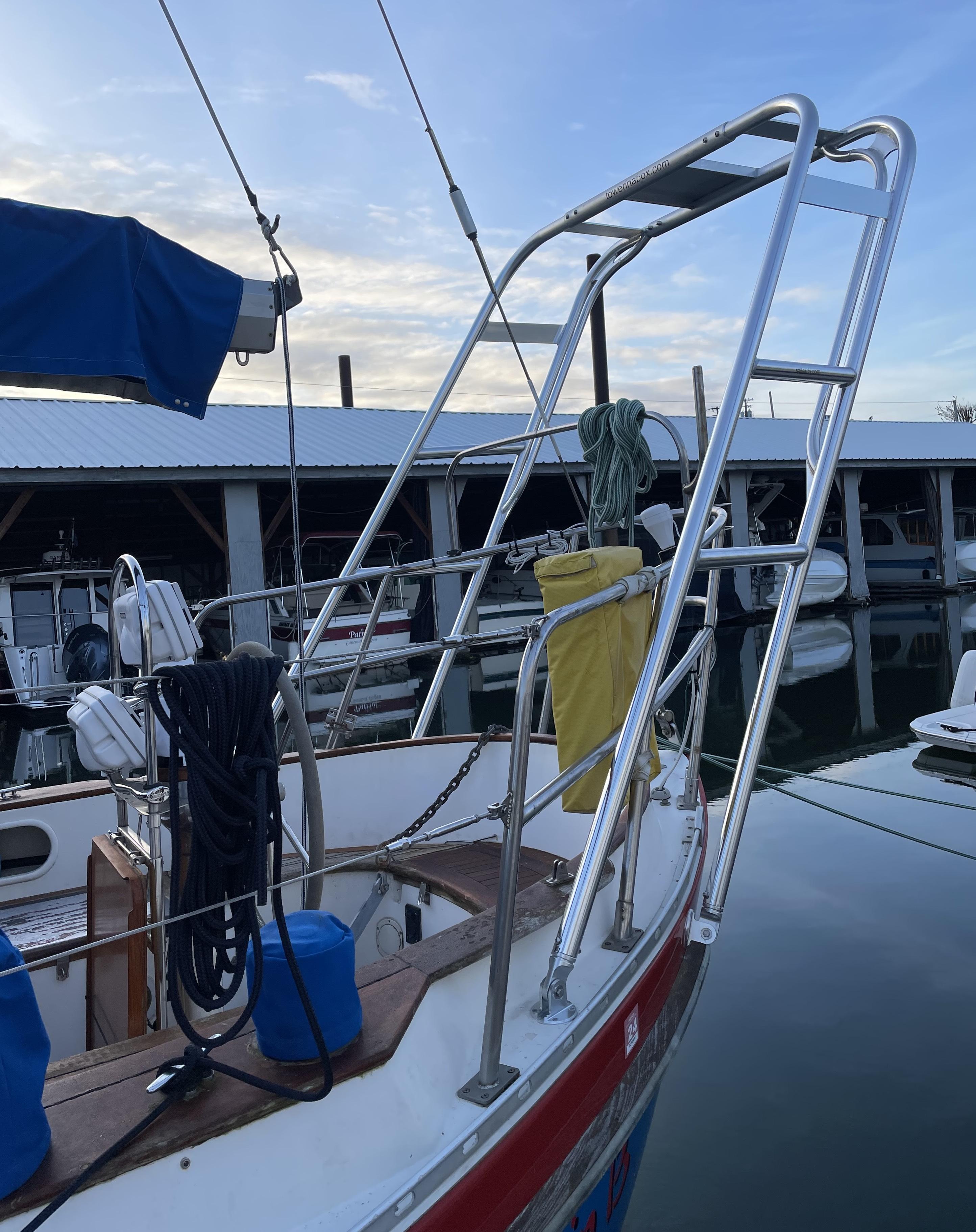 Atlantic Towers Arch installed on the stern of a Tayana sailboat docked near a marina with calm water.