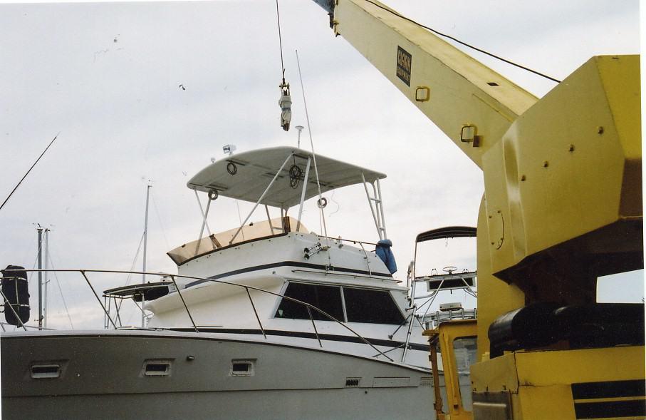 Viking 40 Sedan boat with installed Atlantic Towers Top, docked next to a yellow crane on an overcast day.