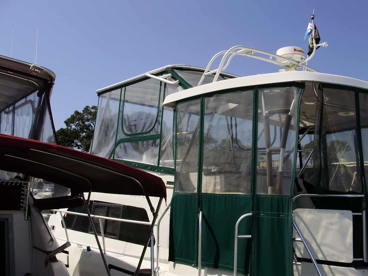 Atlantic Towers Top installed on a Mainship 37 Motor Yacht, featuring a clear enclosure with green accents.