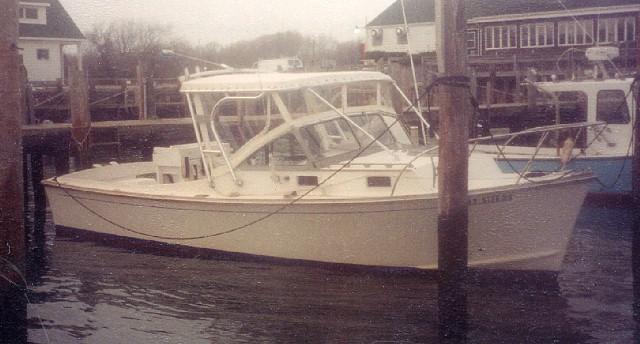 Atlantic Towers Top equipped on a Fortier Boats 26 model, docked at a marina with wooden pilings.