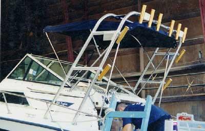 Alt text: Atlantic Towers Arch installed on a Grady White 254 Kingfish boat, featuring rod holders and a blue canopy.