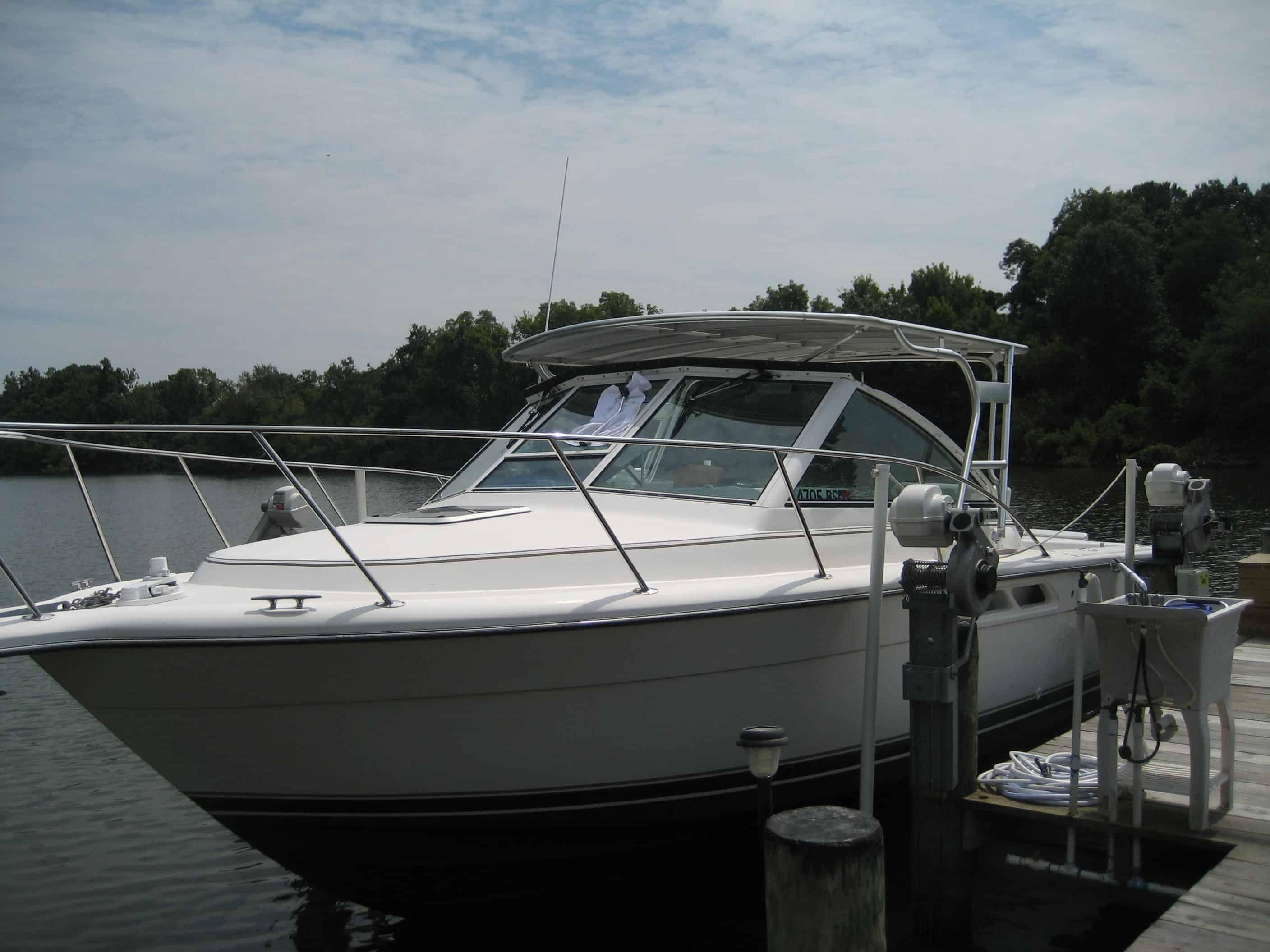 Atlantic Towers Top installed on a boat docked by a serene waterfront with trees in the background.