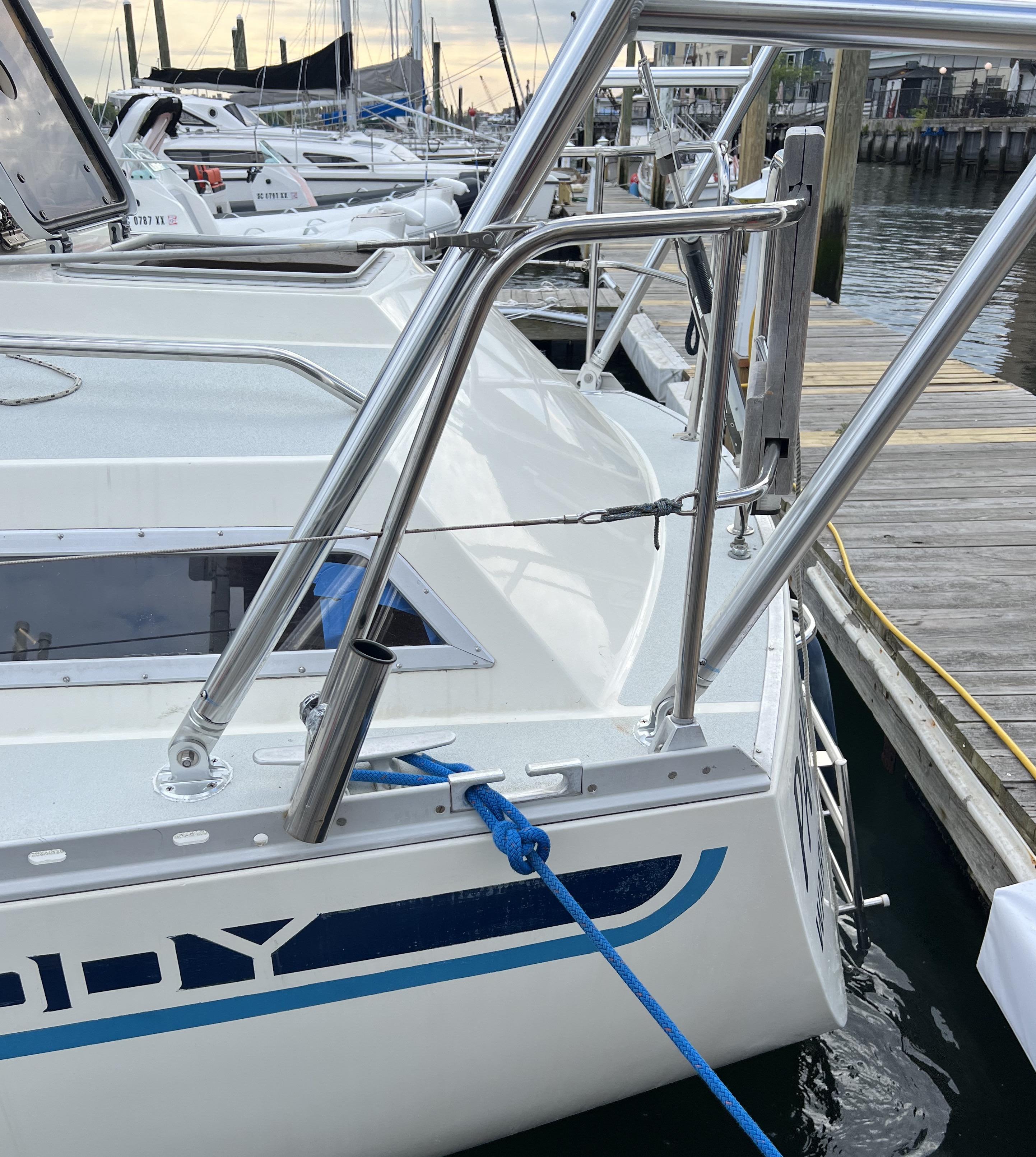 Atlantic Towers Arch installed on a Moody boat, featuring a polished stainless steel frame and blue docking rope.