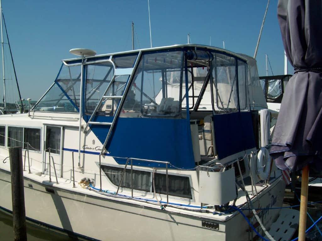 Atlantic Towers Top installed on a Chris Craft 381 Catalina Motor Yacht docked near a wooden pier under clear skies.