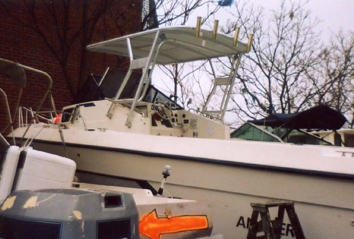 Angler Boats boat with installed Atlantic Towers Top in an outdoor setting near a brick building and trees.