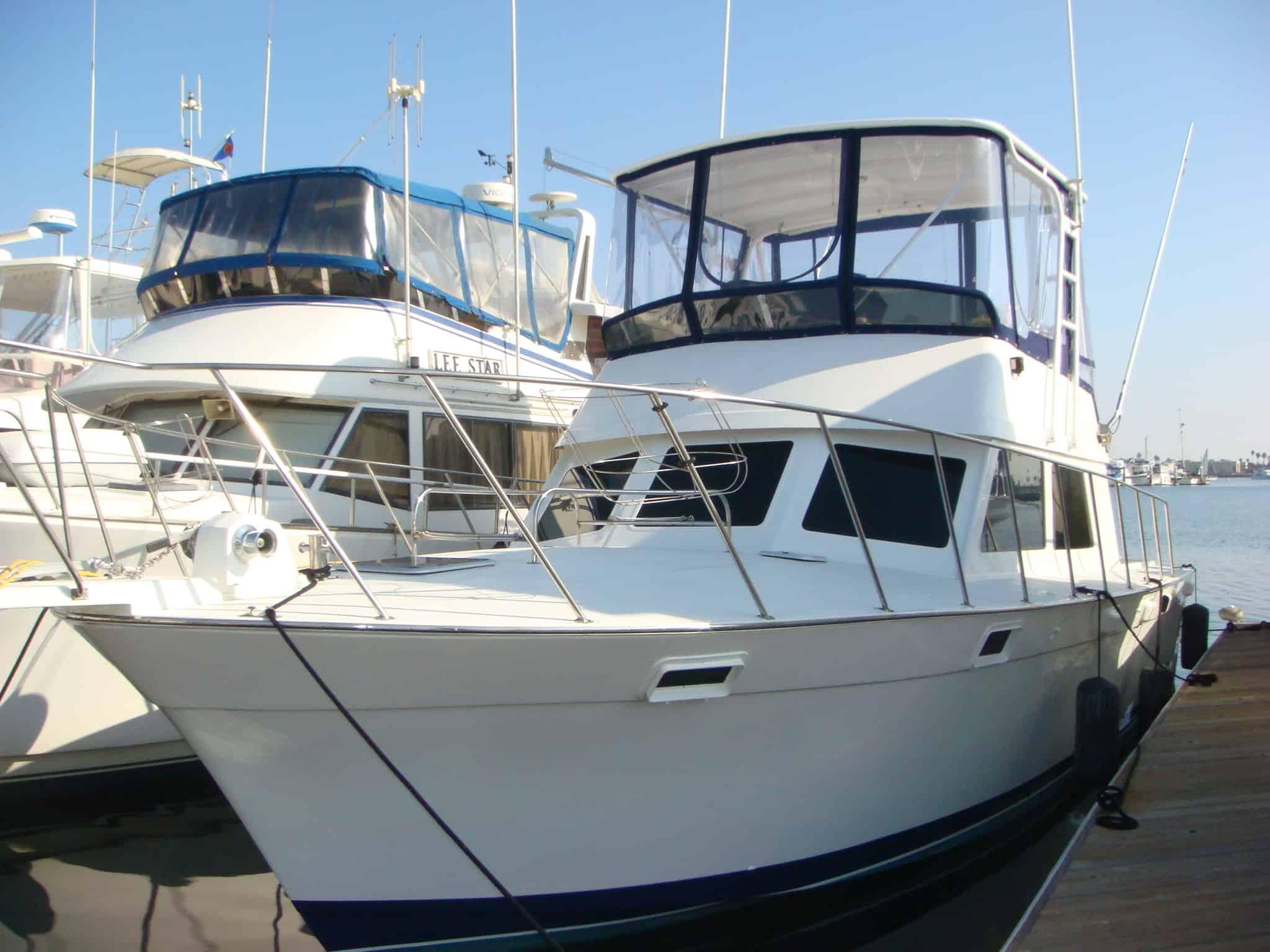 Atlantic Towers Top installed on a Luhrs 40 Sportfisher boat docked beside similar boats in a marina.
