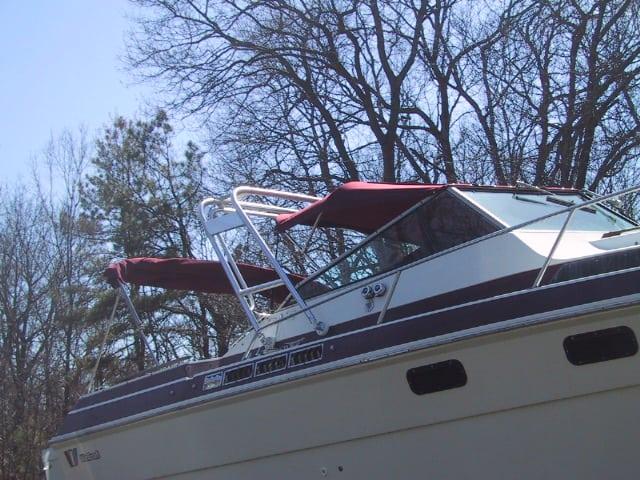 Atlantic Towers arch installed on the cabin area of a Wellcraft 3100 Montego boat with reddish canvas covers.