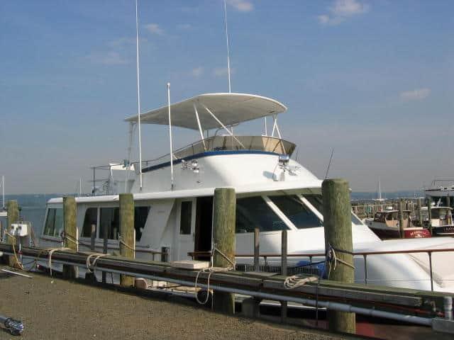 Hattaras 58 Motor Yacht docked with installed Atlantic Towers Top providing shaded upper helm station.
