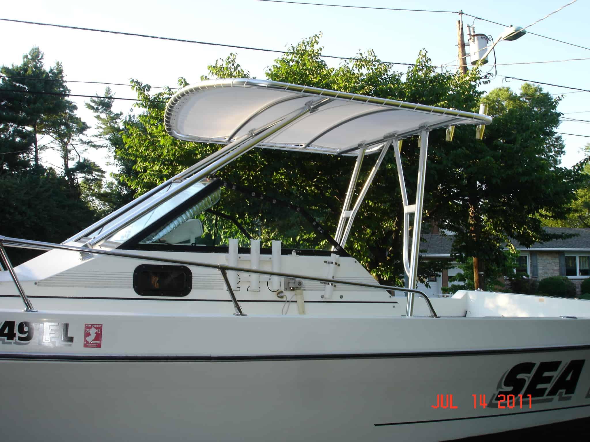 Atlantic Towers Top installed on an IMP 23 Sportsman boat showing a white frame with a canopy above the cockpit.