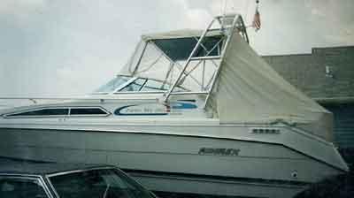 Atlantic Towers Arch installed on a white Rinker 260/265 Fiesta Vee boat with a covered canopy and windshield.