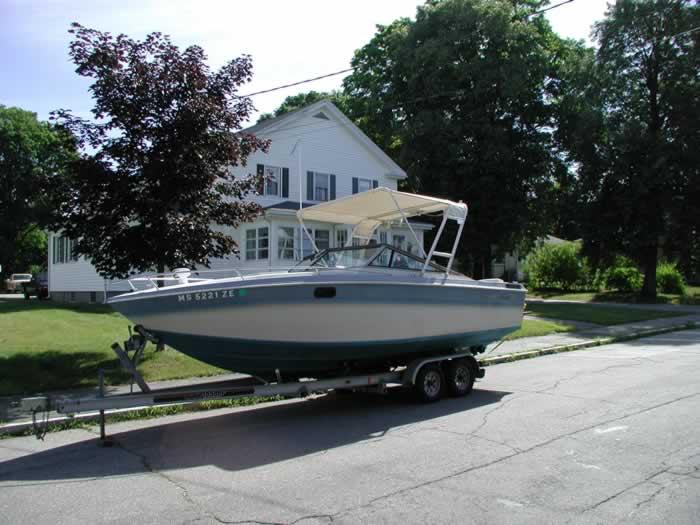 Atlantic Towers Top installed on a Chris Craft Scorpian boat, parked on a trailer near a residential area.
