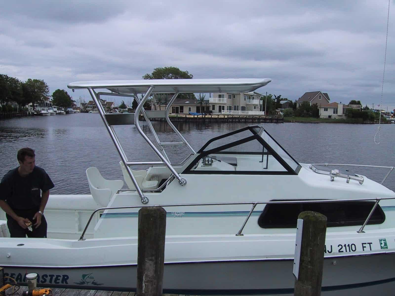 Atlantic Towers Top installed on a Renken 2688 Seamaster boat by the water, with a man working nearby.
