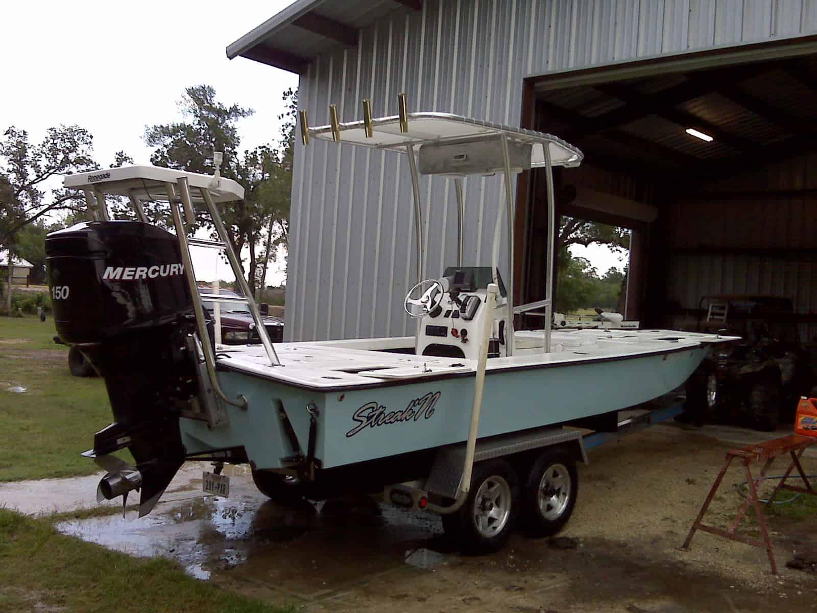 Atlantic Towers T-Top installed on a Renegade Skate boat, parked inside a storage building.