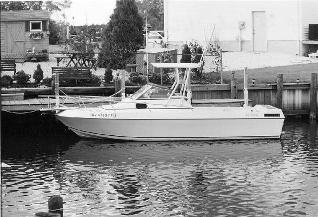 Atlantic Towers Top installed on an IMP 22 Fish boat docked at a marina, surrounded by greenery and structures.