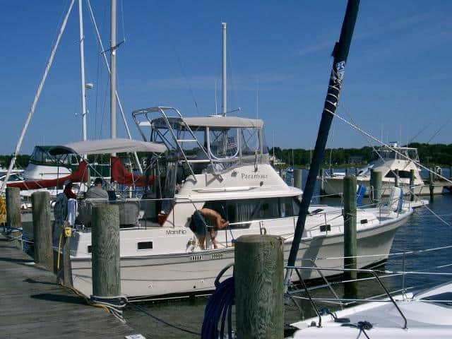 A Mainship 36 Aft Cabin boat docked at a marina with an Atlantic Towers Arch installed.