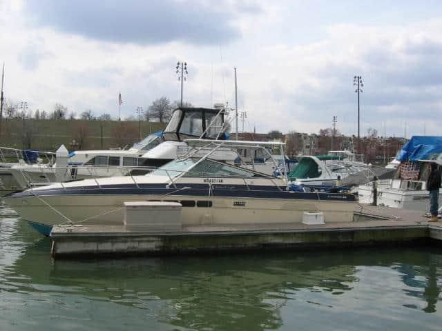 Chris Craft 335 express boat docked at marina with Atlantic Towers Top installed above cockpit area.