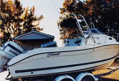 Atlantic Towers Arch installed on a Seaswirl 2300 Striper boat, displayed on a trailer near trees.