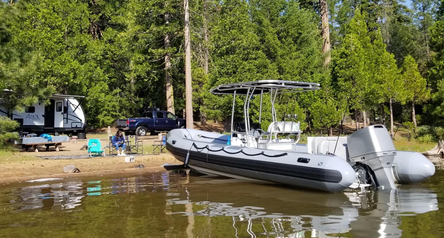 Atlantic Towers T-Top installed on an AB Inflatables boat docked at a serene lakeside campsite.