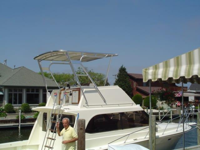 Atlantic Towers Top installed on an Egg Harbor 33 FB boat with a man standing nearby at the dock.