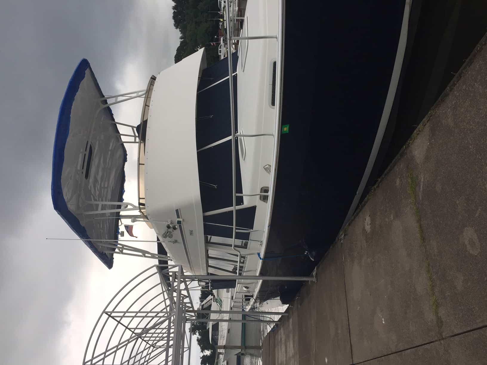 Atlantic Towers Top installed on a Mainship boat, docked with a cloudy sky overhead.
