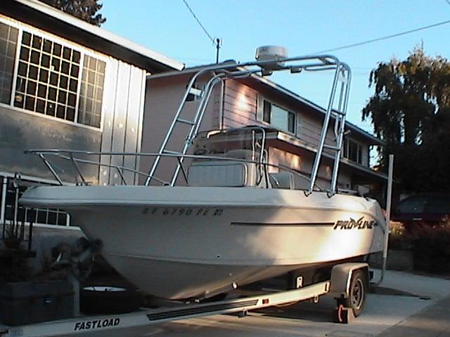 Pro Line 180 Sport Utility boat with installed Atlantic Towers arch on trailer parked in residential driveway.