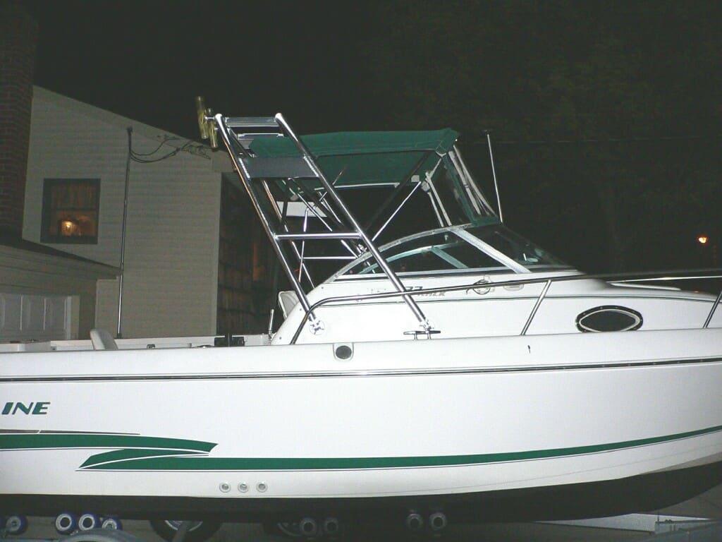 Atlantic Towers Arch installed on a Pro Line 22 walk boat, featuring a slender white hull and green accents.