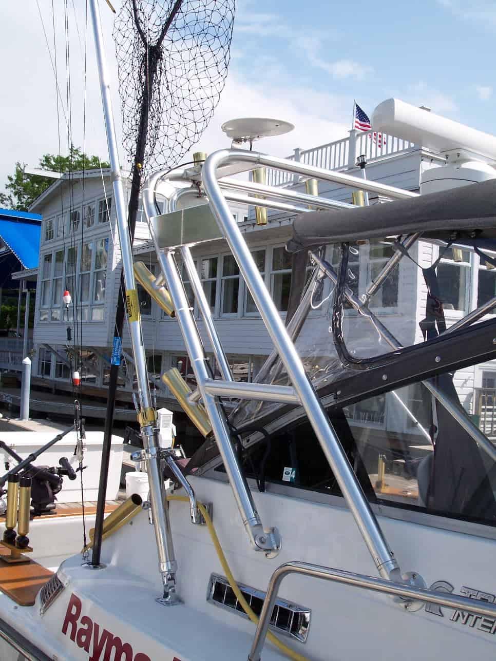 Atlantic Towers Arch mounted on a Trojan 10 Meter Express boat with fishing gear and a dockside background.