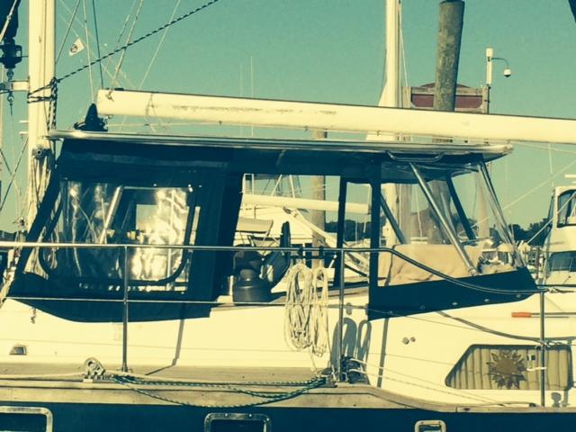Atlantic Towers Top installed on a Trans Pac boat, featuring a covered helm with clear windows and a sail on the mast.