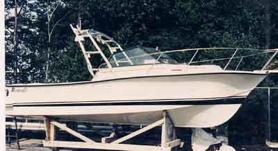 Rampage 24 Express boat on a wooden stand equipped with an Atlantic Towers Arch against a forest background.