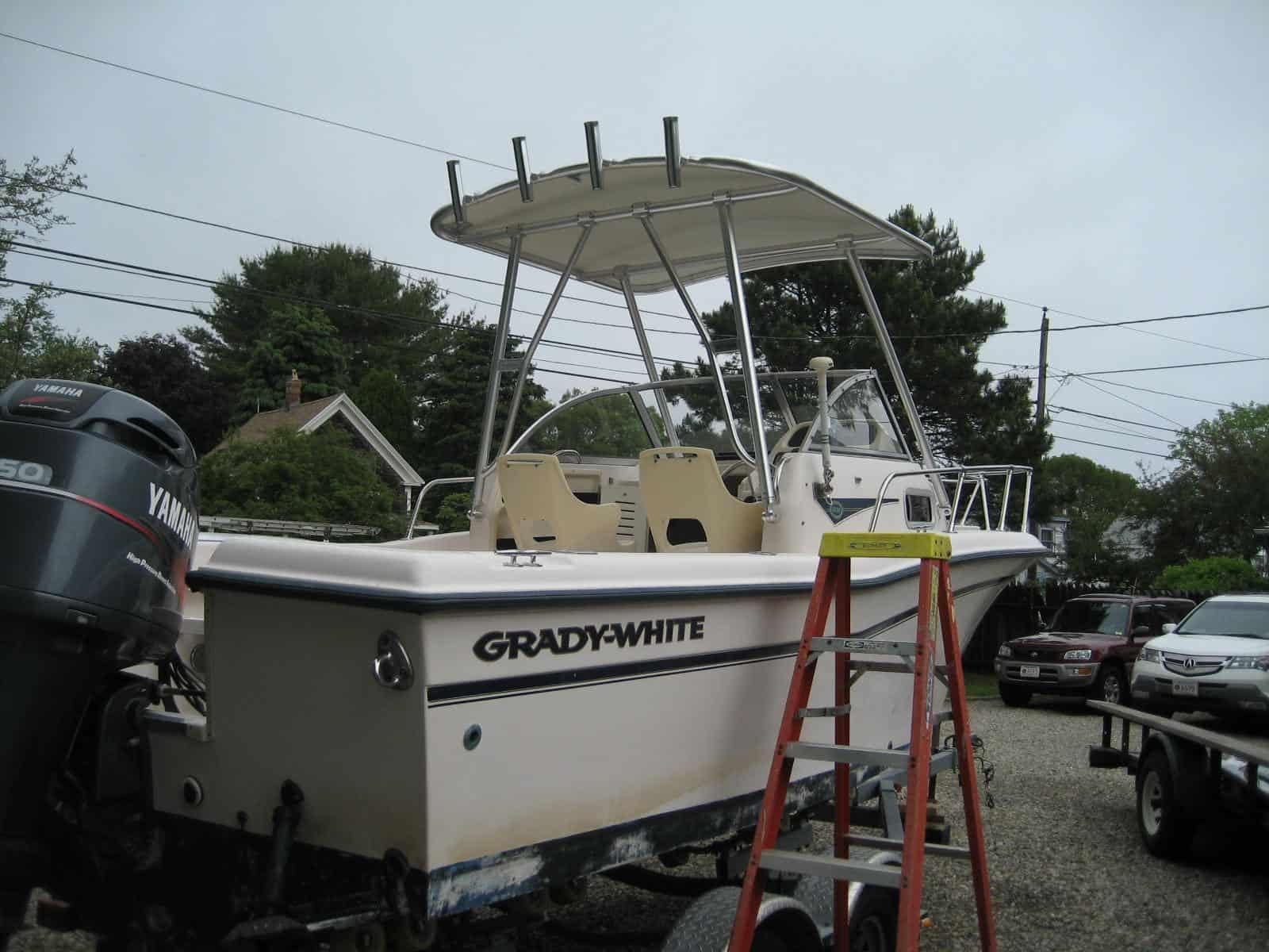 Atlantic Towers Top installed on a Grady White 204 Overnighter walkaround boat docked by wooden piers.