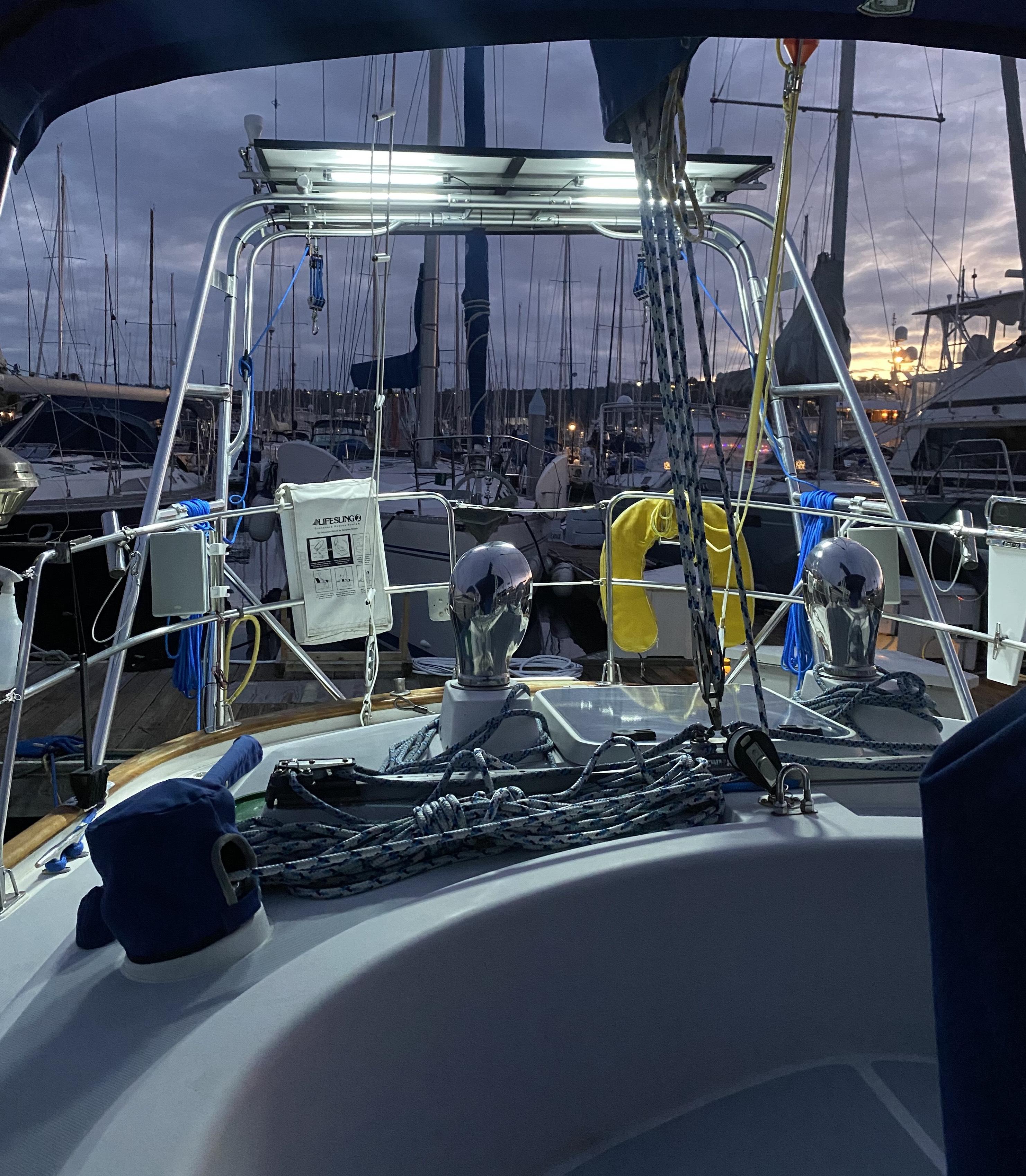 Atlantic Towers Arch installed on a boat, featuring lights, rigging, and accessories with a marina backdrop at dusk.