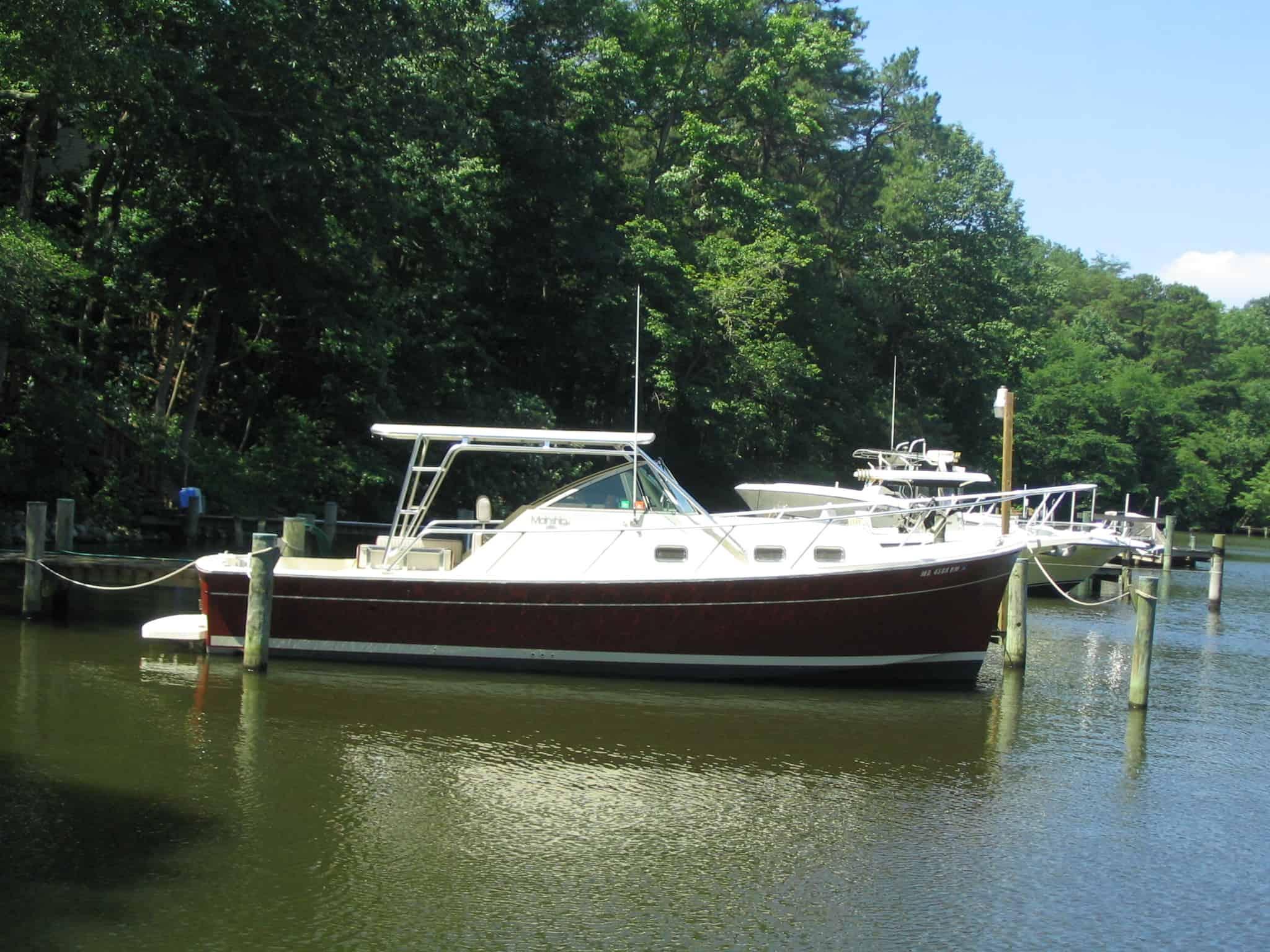 Atlantic Towers Top installed on a Mainship 30 Pilot cruiser boat with calm water and clear sky background.