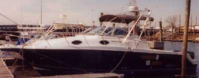Atlantic Towers Arch installed on a Wellcraft 290 Coastal boat docked at a marina with calm water.