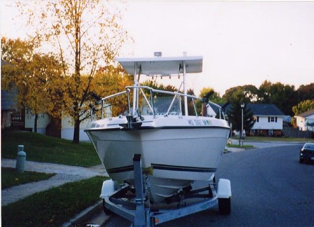 Atlantic Towers T-Top installed on Seaswirl 2100/2101 Console boat on a trailer parked on a suburban street in fall.
