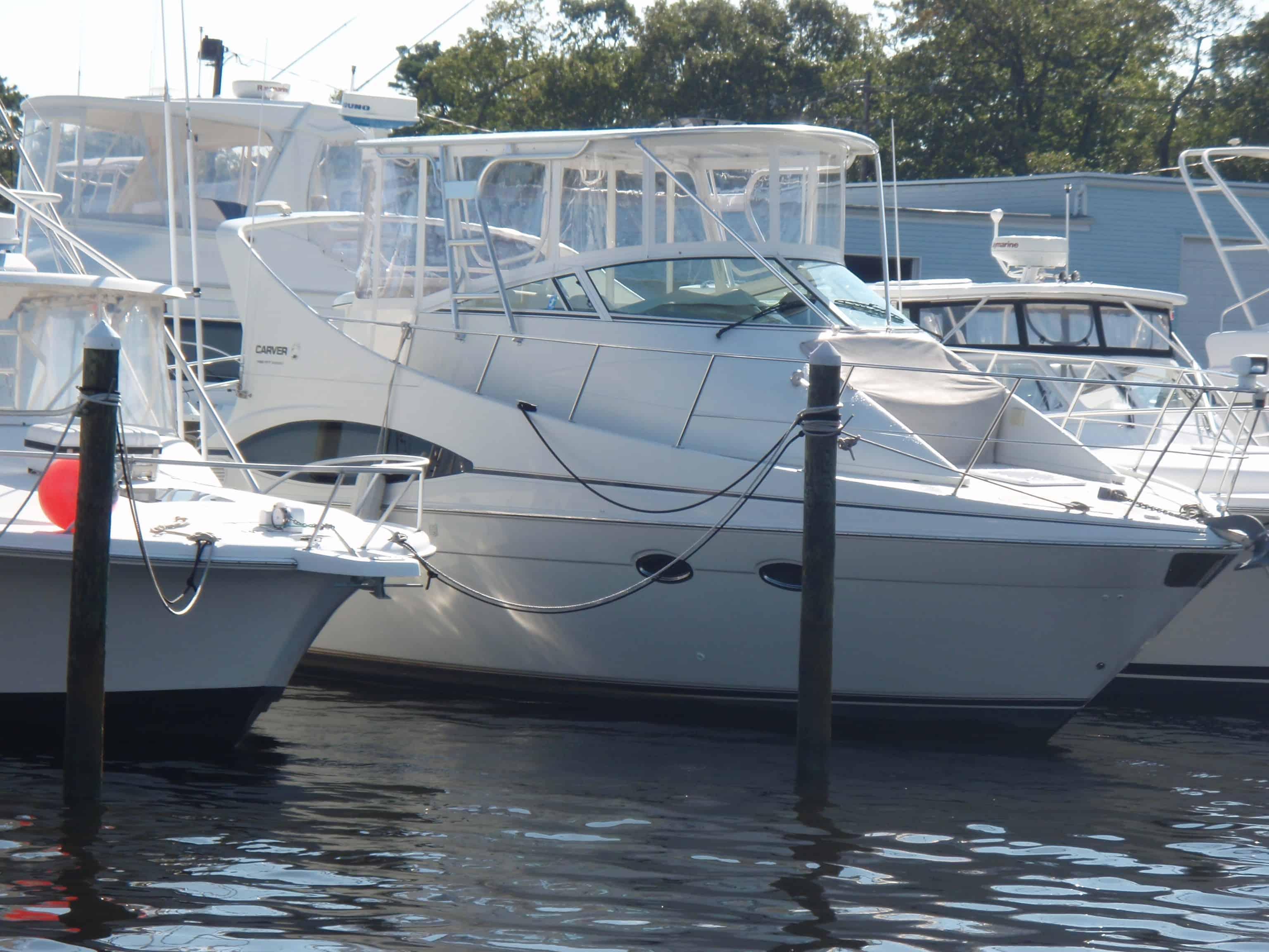 Atlantic Towers Top installed on a Carver 350 Mariner docked at a marina alongside other boats.