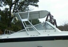 Atlantic Towers Top installed on a Formula boat, showcasing a silver frame and canopy design against a natural backdrop.