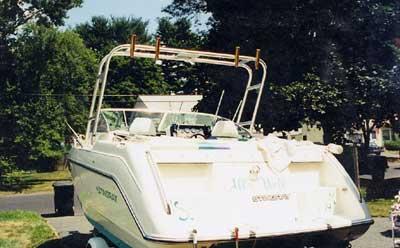 Atlantic Towers Arch installed on the stern of a Stingray 719 boat parked near trees and a road.