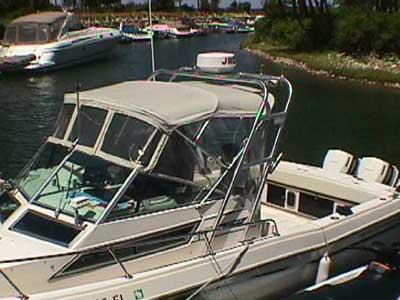 Atlantic Towers Arch installed on a Grady White 230/231/232 Gulfstream boat docked near a marina with other boats.