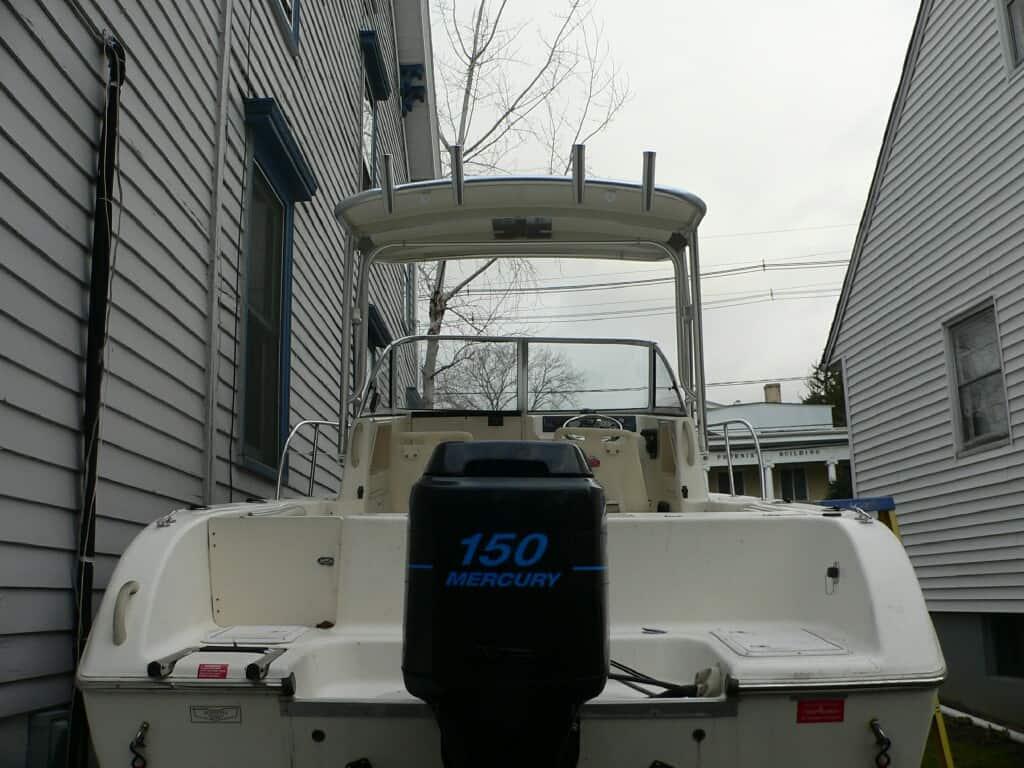 Rear view of Sea Fox 210 Walkaround boat with Atlantic Towers Top installed and a 150 Mercury outboard motor.