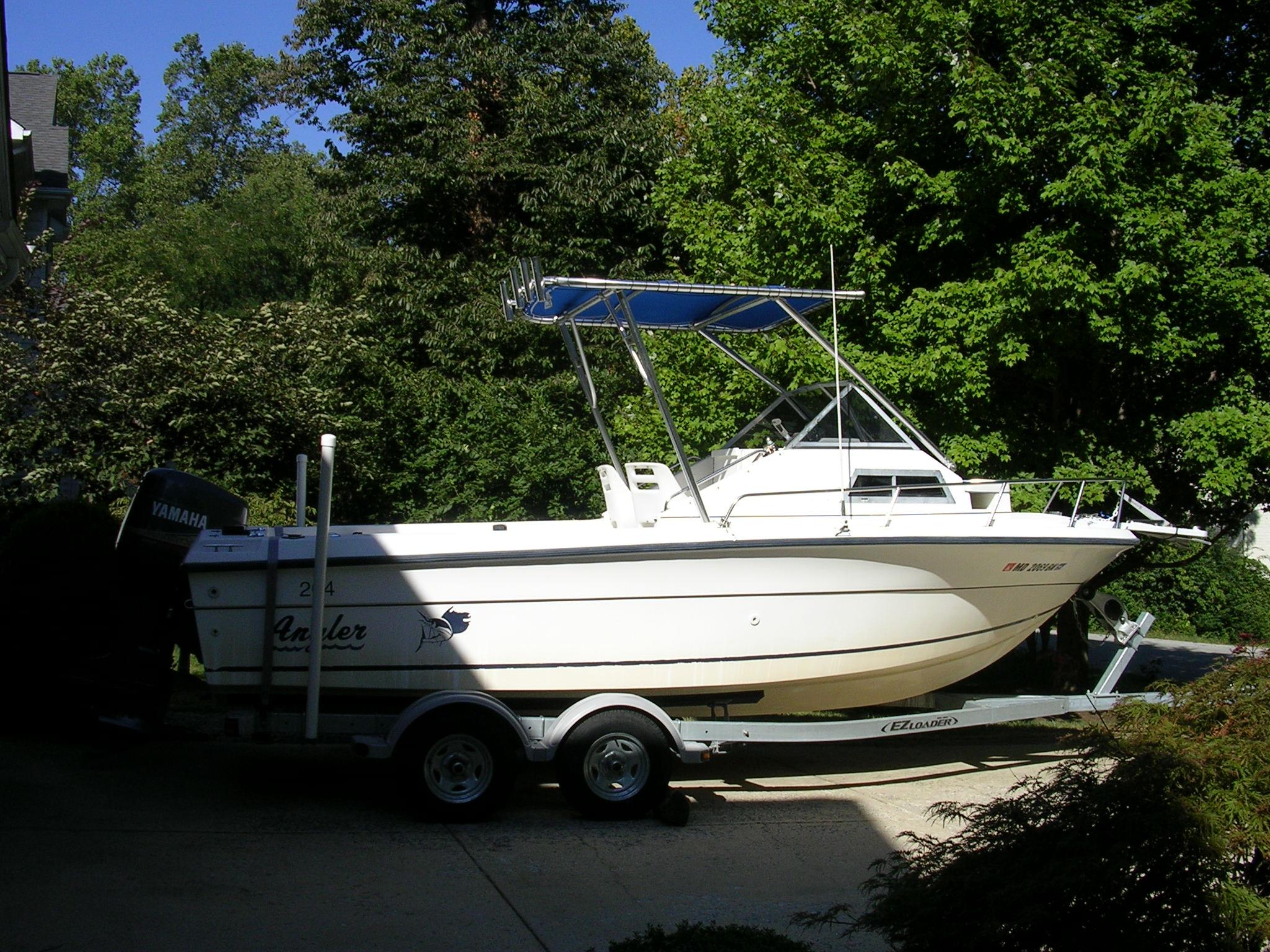 Atlantic Towers Top installed on an Angler Boats model trailer in a lush outdoor setting.