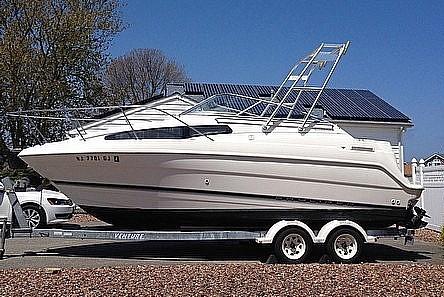 Atlantic Towers Arch installed on a Bayliner boat, displayed on a trailer with a clear sky background.
