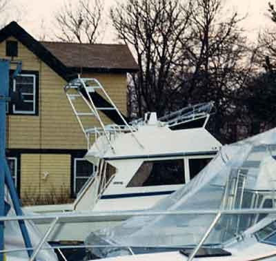 Atlantic Towers arch installed on a Viking 35 Convertible boat, docked near a house with bare trees.