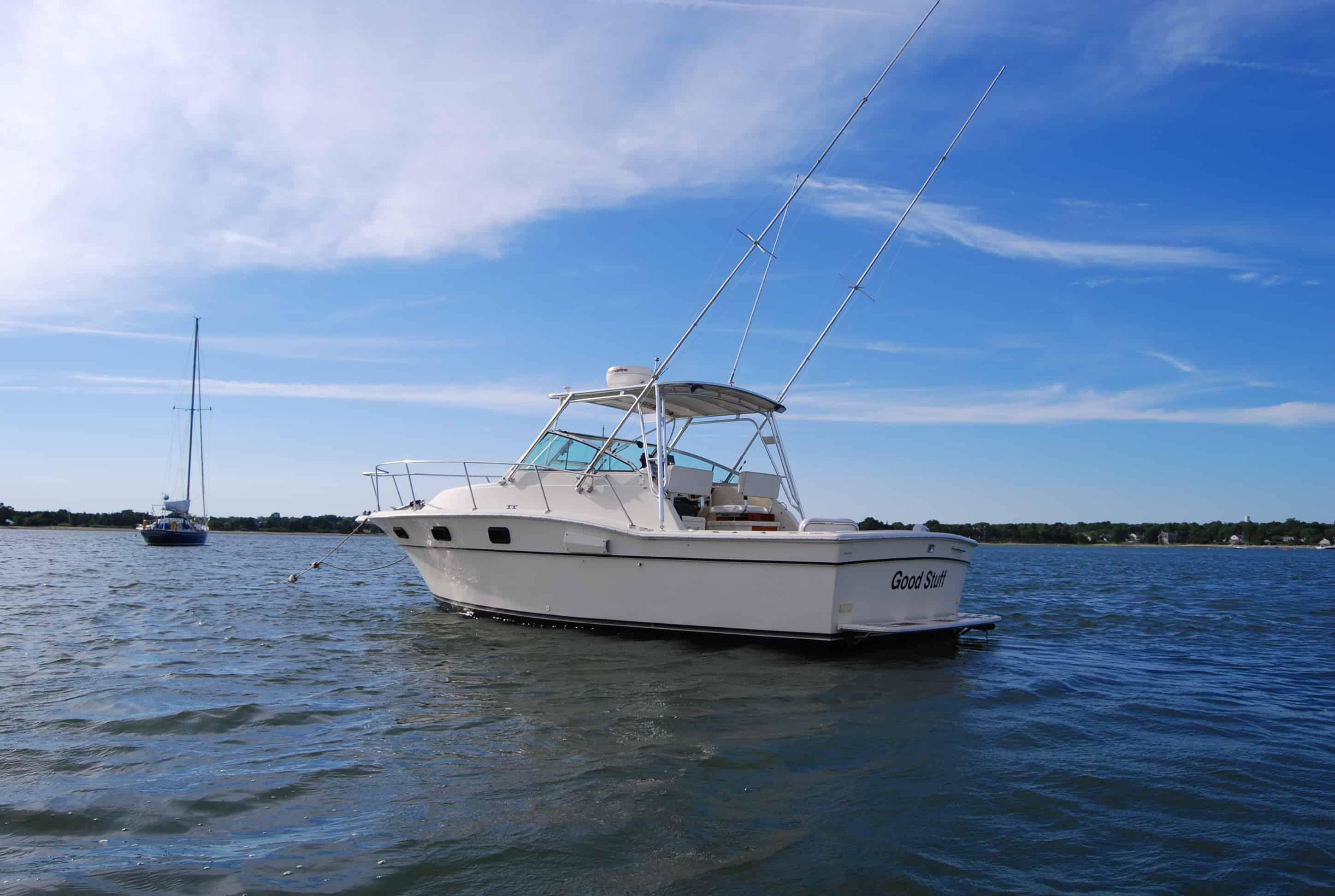 Atlantic Towers Top installed on an Aquasport 290 Express boat, anchored on a calm waterway under a clear blue sky.