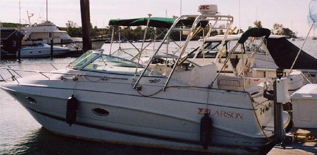 Atlantic Towers Arch installed on a Larson 260 Cabrio boat docked at a marina with other boats nearby