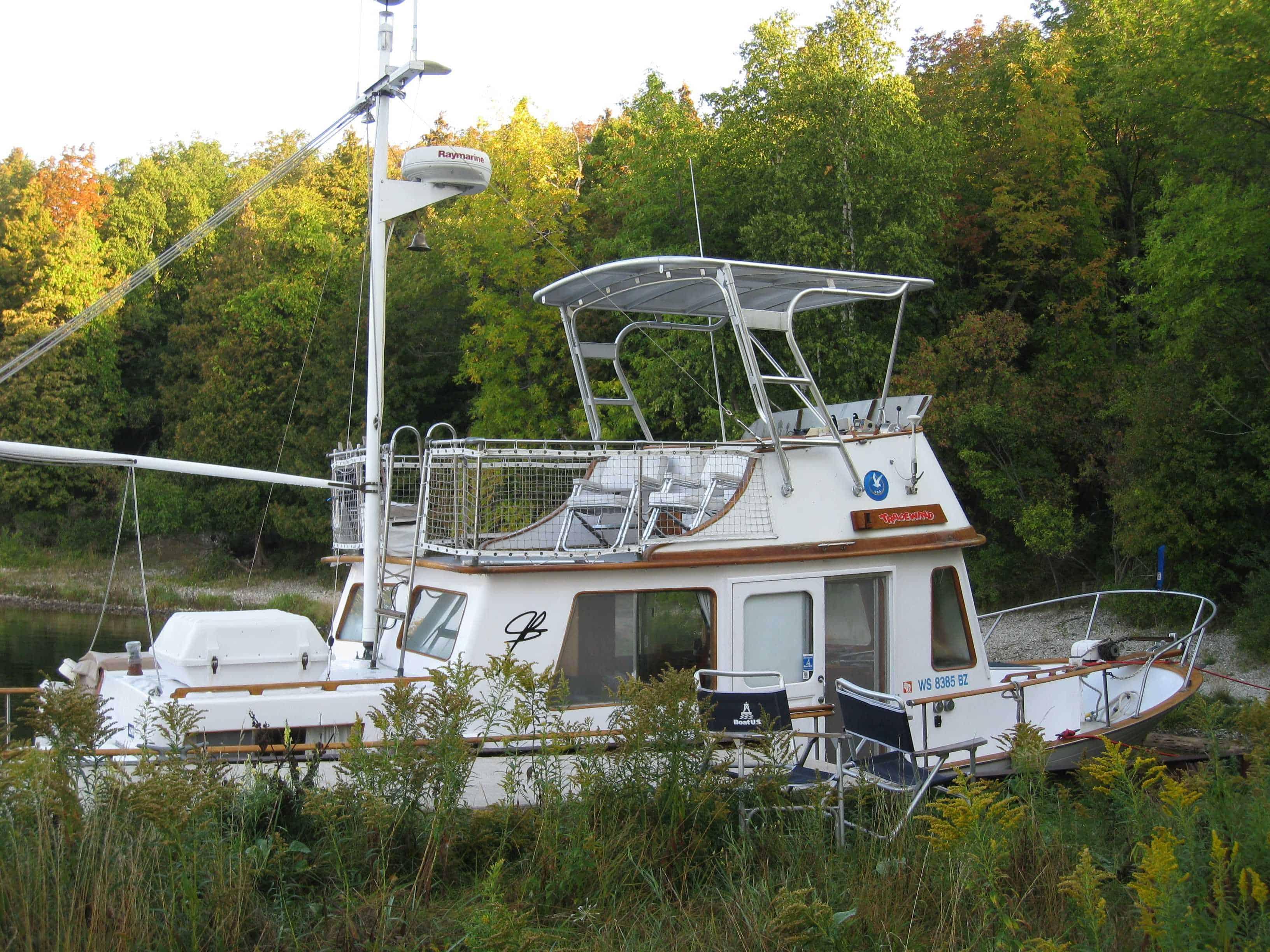 Atlantic Towers Top installed on a Marine Trader 34 Trawler docked near greenery and water.