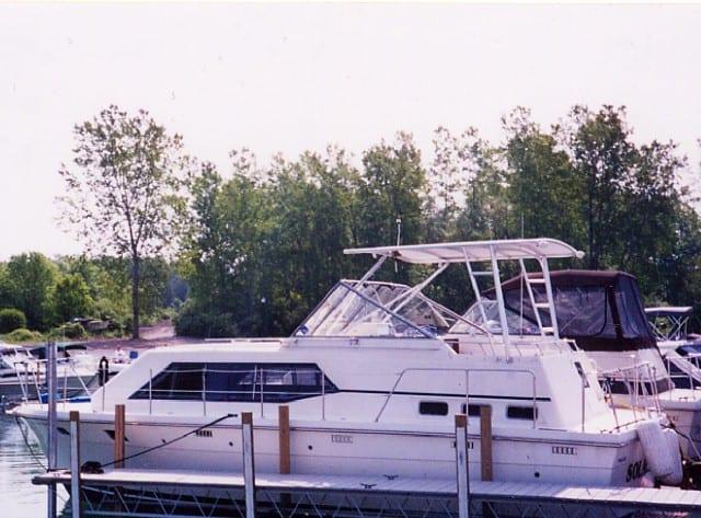 Trojan 36 Tri-Cabin yacht docked with an installed Atlantic Towers Top frame above the helm area.